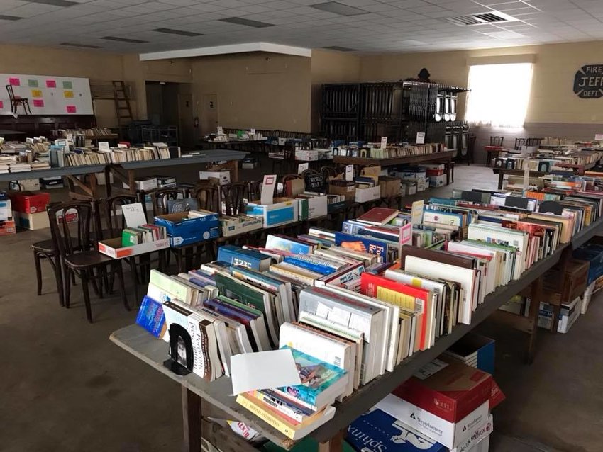 Tables groan under books at a past Firehouse Book Sale